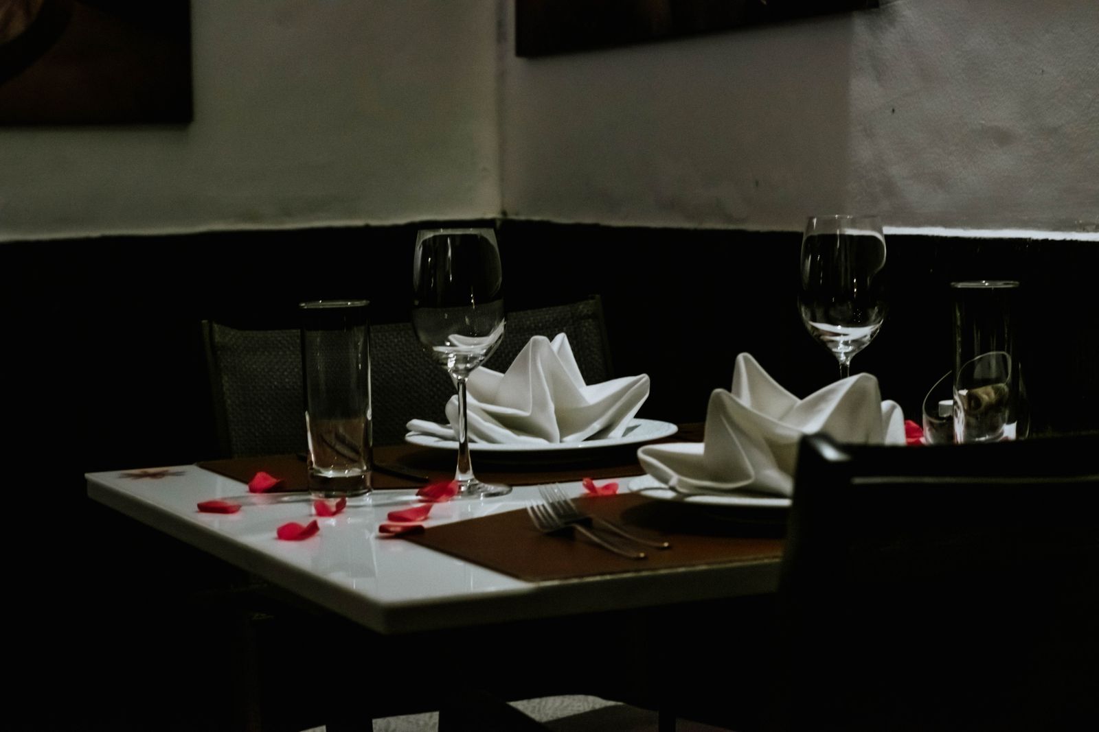 Candlelit table set for dinner in a warm dining room